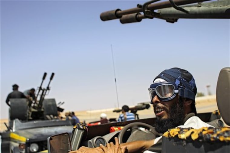 Libyan rebel fighters prepare to patrol the village of Heisha on Tuesday.